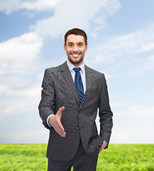 Image showing businessman with open hand ready for handshake