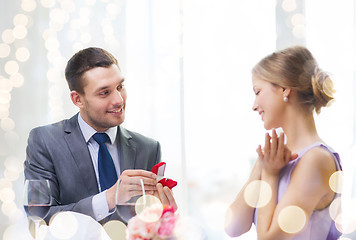 Image showing man proposing to his girlfriend at restaurant