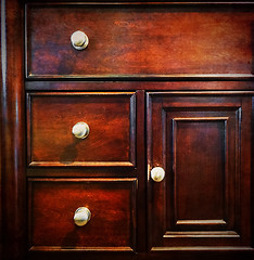 Image showing Dark wooden chest of drawers
