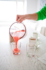 Image showing Pouring a delicious strawberry smoothie