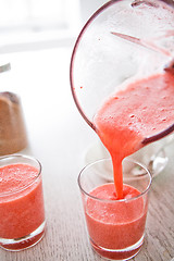 Image showing Pouring a delicious strawberry smoothie