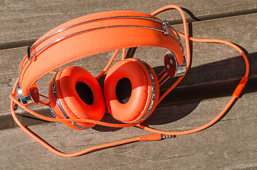 Image showing Vibrant orange wired headphones
