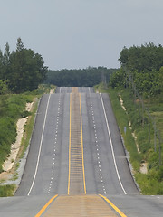 Image showing Empty road over a hill