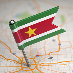 Image showing Suriname Small Flag on a Map Background.