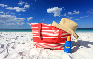 Image showing Summertime sun protection sunscreen hat at the beach