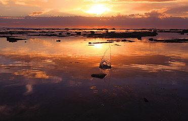 Image showing Sunrise pebble slash in ocean rock reef