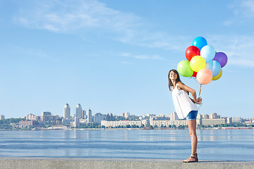 Image showing Happy young woman with colorful balloons