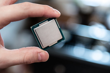 Image showing Human hand holding modern processor