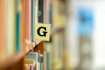 Image showing Library bookshelf closeup with letter