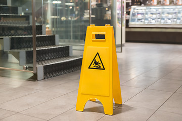 Image showing Yellow sign alerts for wet floor