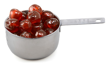 Image showing Sticky whole glace cherries in a cup measure