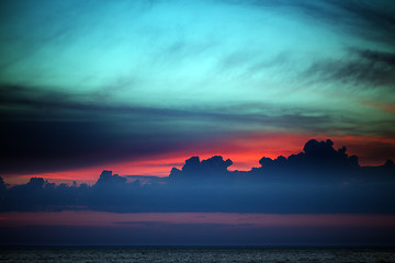Image showing Multicolor sunset sky with clouds on lake