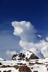 Image showing Rocks in snow and blue sky with clouds