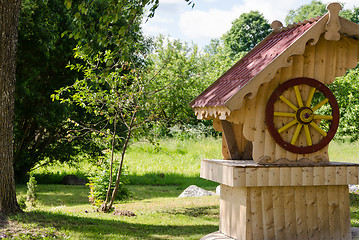 Image showing wooden handmade well in summer garden 