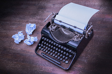 Image showing Vintage typewriter and old books
