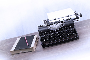 Image showing Vintage typewriter and old books