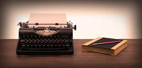 Image showing Vintage typewriter and old books