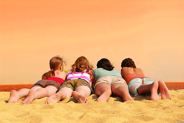 Image showing Four girls at orange sea