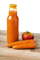 Image showing Bottle with carrots juice and an apple