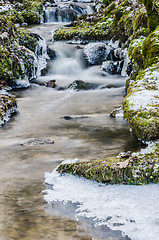 Image showing The flow of water in the spring of icicles and ice