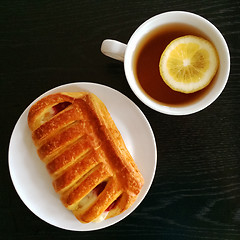 Image showing Pastry and cup of tea with lemon