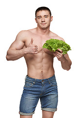 Image showing Fit male holding vegetables and showing thumbs up