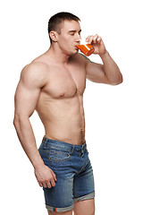 Image showing Muscular male drinking juice