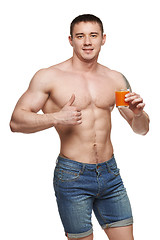 Image showing Fit male holding vegetables and showing thumbs up