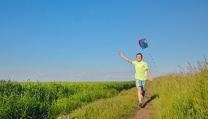 Image showing boy  running with kite