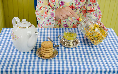 Image showing hand prepare marigold herb tea 