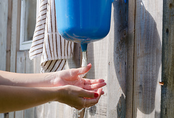 Image showing Closeup of gardener girl woman wash hands 