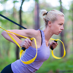 Image showing Training with fitness straps outdoors.