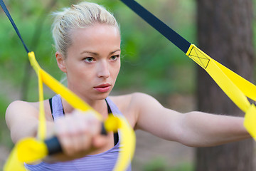 Image showing Training with fitness straps outdoors.