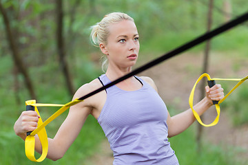 Image showing Training with fitness straps outdoors.