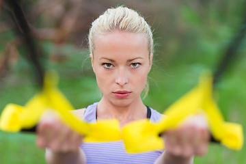 Image showing Training with fitness straps outdoors.