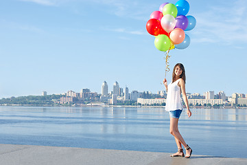 Image showing Happy young woman with colorful balloons