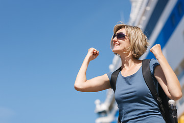 Image showing Woman with map, in front of cruise liner