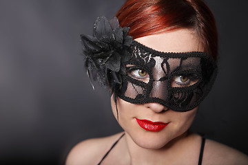 Image showing Red head woman wearing mask