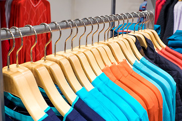 Image showing Clothing on hangers in shop