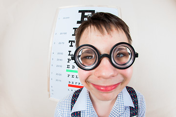 Image showing Funny boy wearing spectacles in an office at the doctor