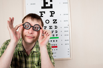 Image showing Funny manwearing spectacles in an office at the doctor