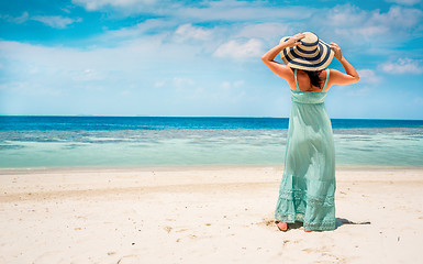 Image showing Girl walking along a tropical beach in the Maldives.