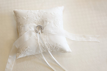 Image showing Wedding rings on a white ring pillow