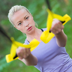 Image showing Training with fitness straps outdoors.