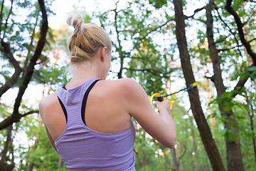 Image showing Training with fitness straps outdoors.