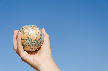 Image showing global earth in hand on blue sky background, Asia  