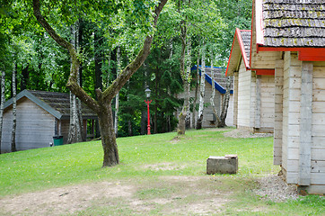 Image showing wooden home sides row in green summer park