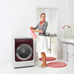 Image showing housewife keeps detergent