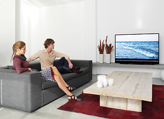 Image showing couple sitting on the sofa watching tv ll