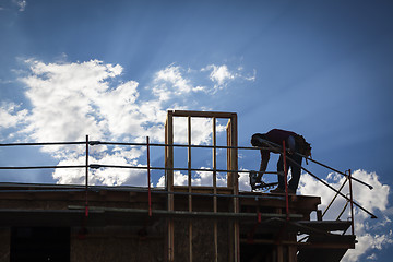 Image showing Construction Worker Silhouette on Roof